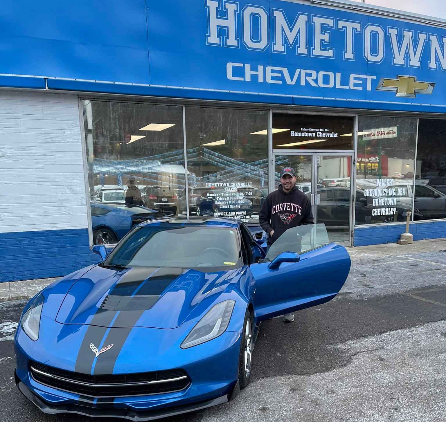 A customer with their used Corvette at our dealership in Waverly, OH